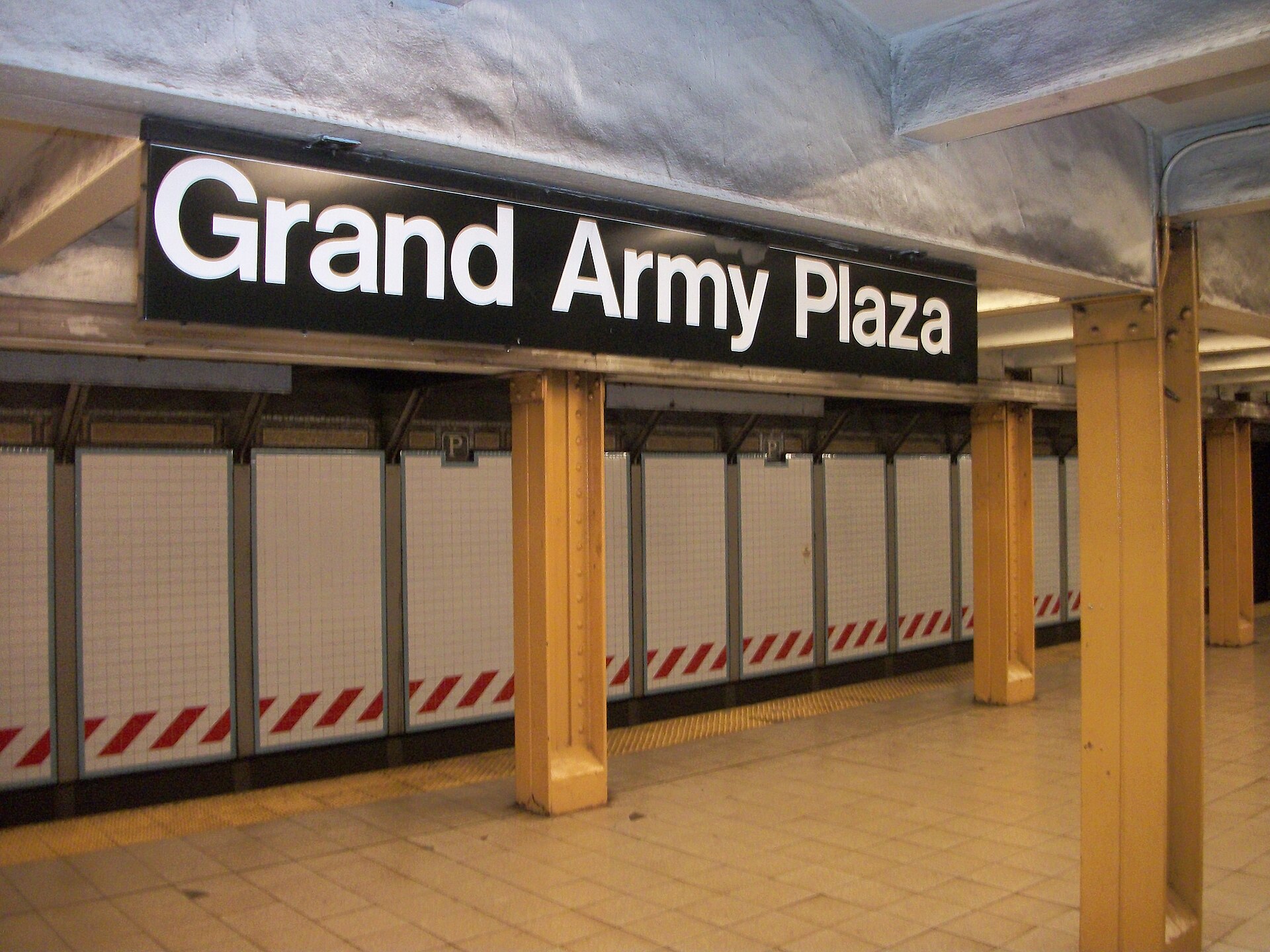 Grand Army Plaza station sign in white Helvetica on black, New York City Subway